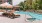 a pool with lounge chairs and umbrellas