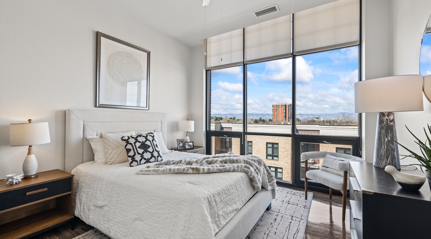 Generous bedroom offerings to fit every family a bedroom with a nightstand, dresser and a window