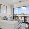 a bedroom with a nightstand, dresser and a window