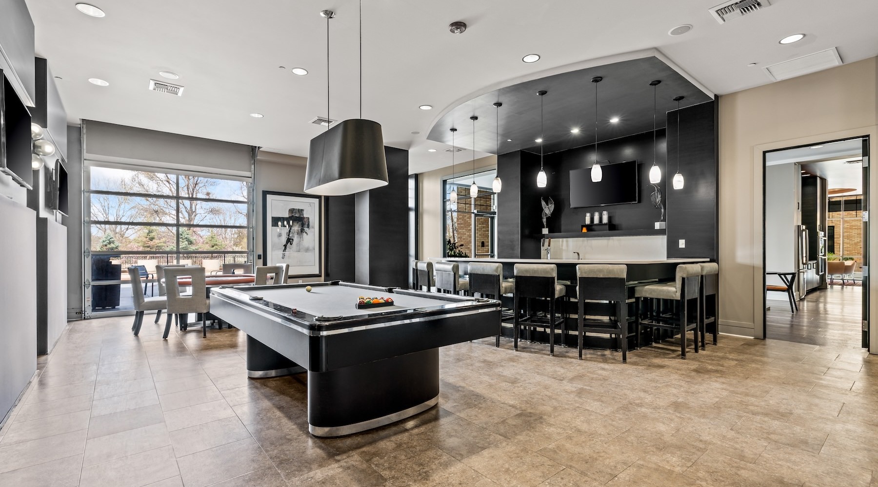 State-of-the-art amenities a room with games, tv's, tables and chairs