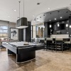 a room with games, tv's, tables and chairs