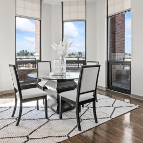 Spacious and well-lit living spaces dining room surrounded by large windows