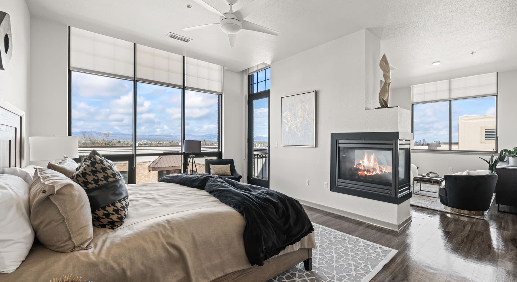 double sided fireplace in large bedroom with mountain views